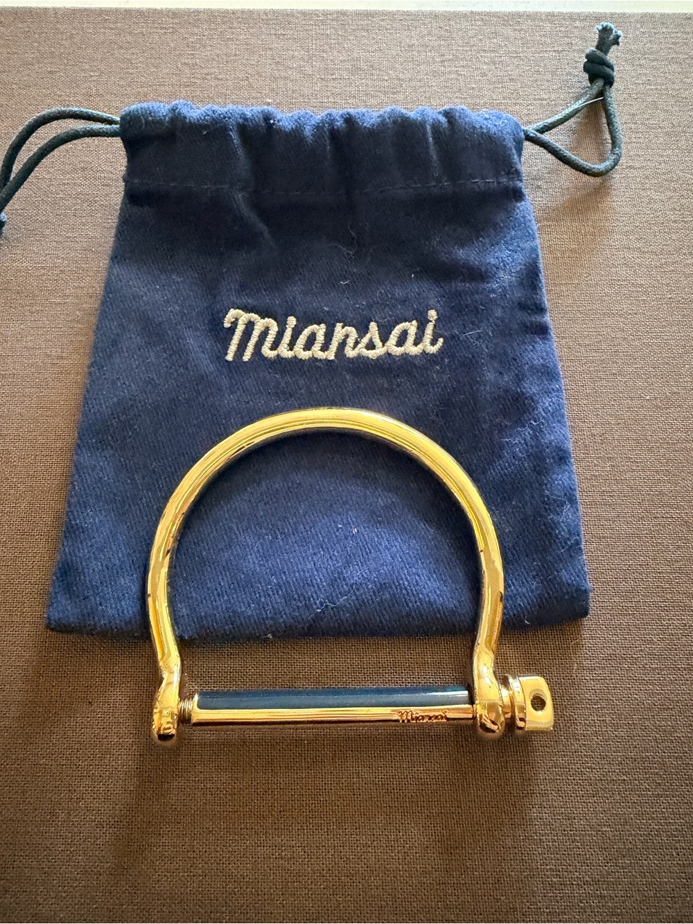 Miansai Gold Tone Bangle with Blue Bar Accent